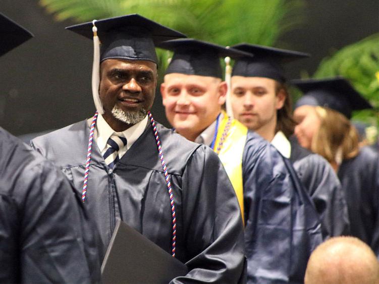 Graduates wearing caps and gowns smiling